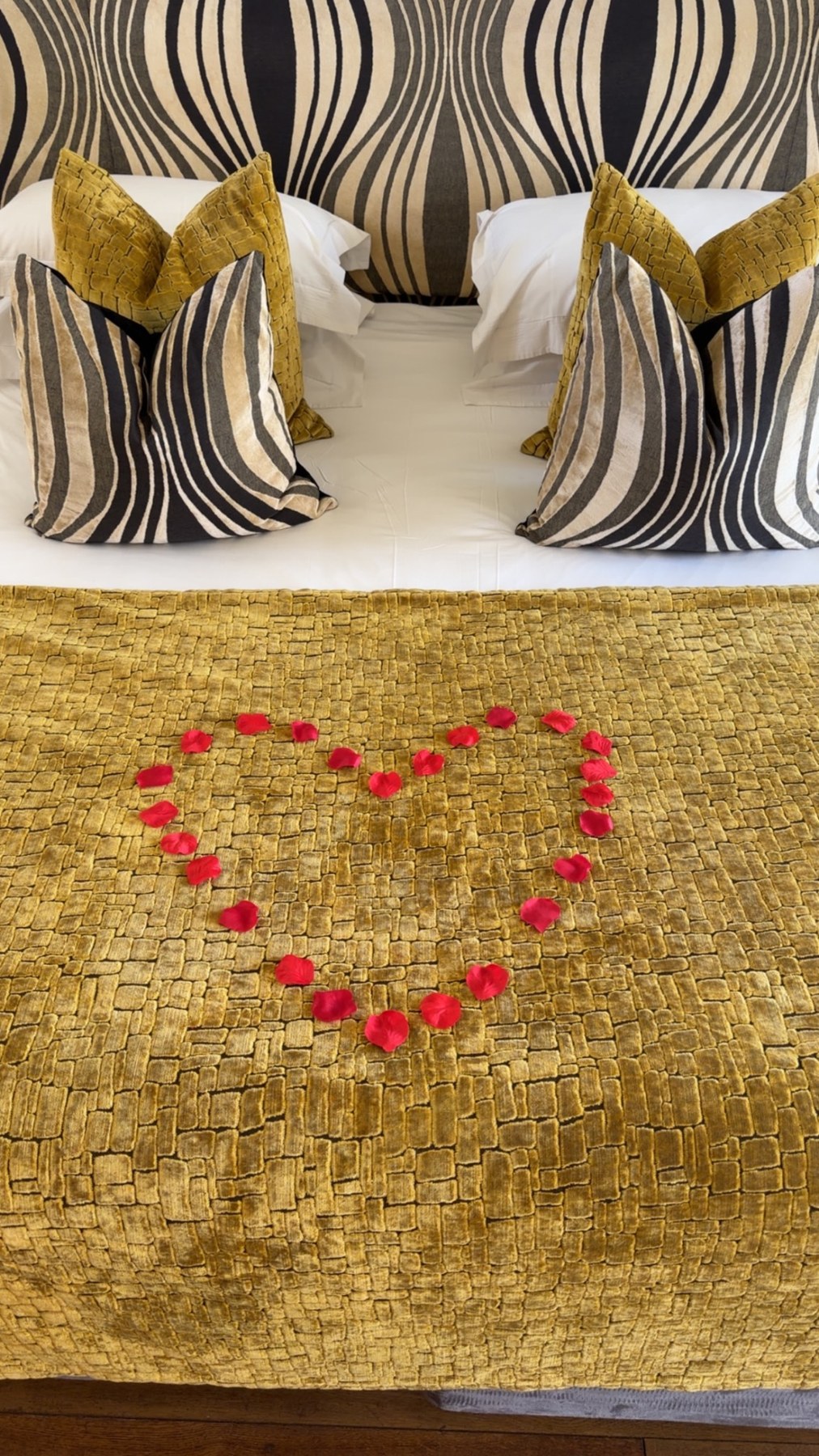 Decorative heart of rose petals on the bed at Channels Hotel